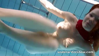 Redhead Mia stripping below-ground